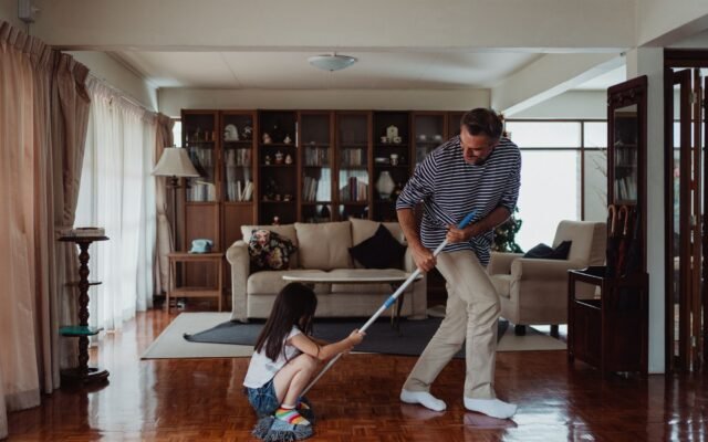 Person cleaning a tidy home living space