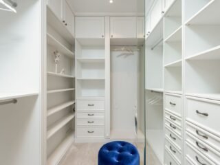 Well organized closet with vertical shelving and labeled bins