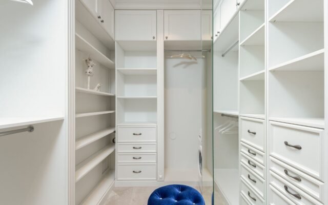 Well organized closet with vertical shelving and labeled bins