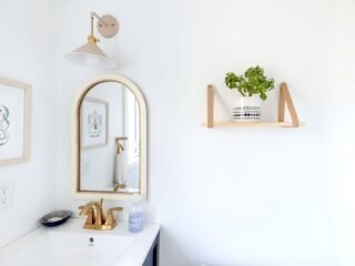 Person installing a floating shelf on a wall