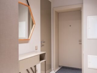 Organized home entryway with a storage bench and wall hooks