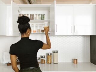 Organized kitchen pantry shelves with labeled containers