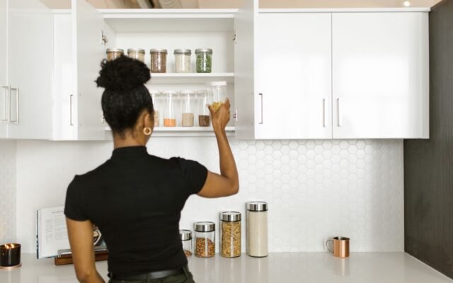 Organized kitchen pantry shelves with labeled containers