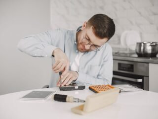 Technician inspecting a kitchen appliance
