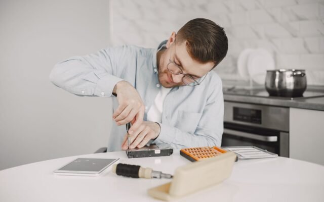 Technician inspecting a kitchen appliance