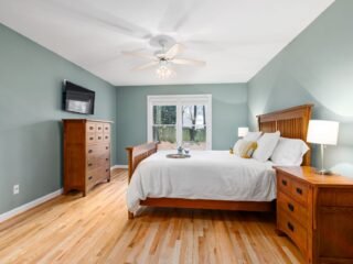 Welcoming guest room with fresh linens and warm lighting