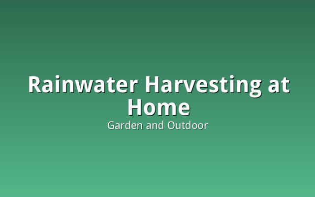 A residential rainwater collection tank connected to a home gutter downspout system